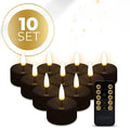 Set of four black LED tealight candles showing flame-effect light.
