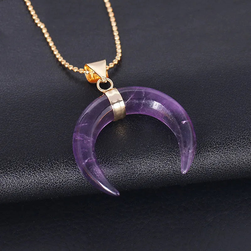 Natural stone moon pendant necklace on a copper chain with adjustable length, shown in pink and purple colour options.