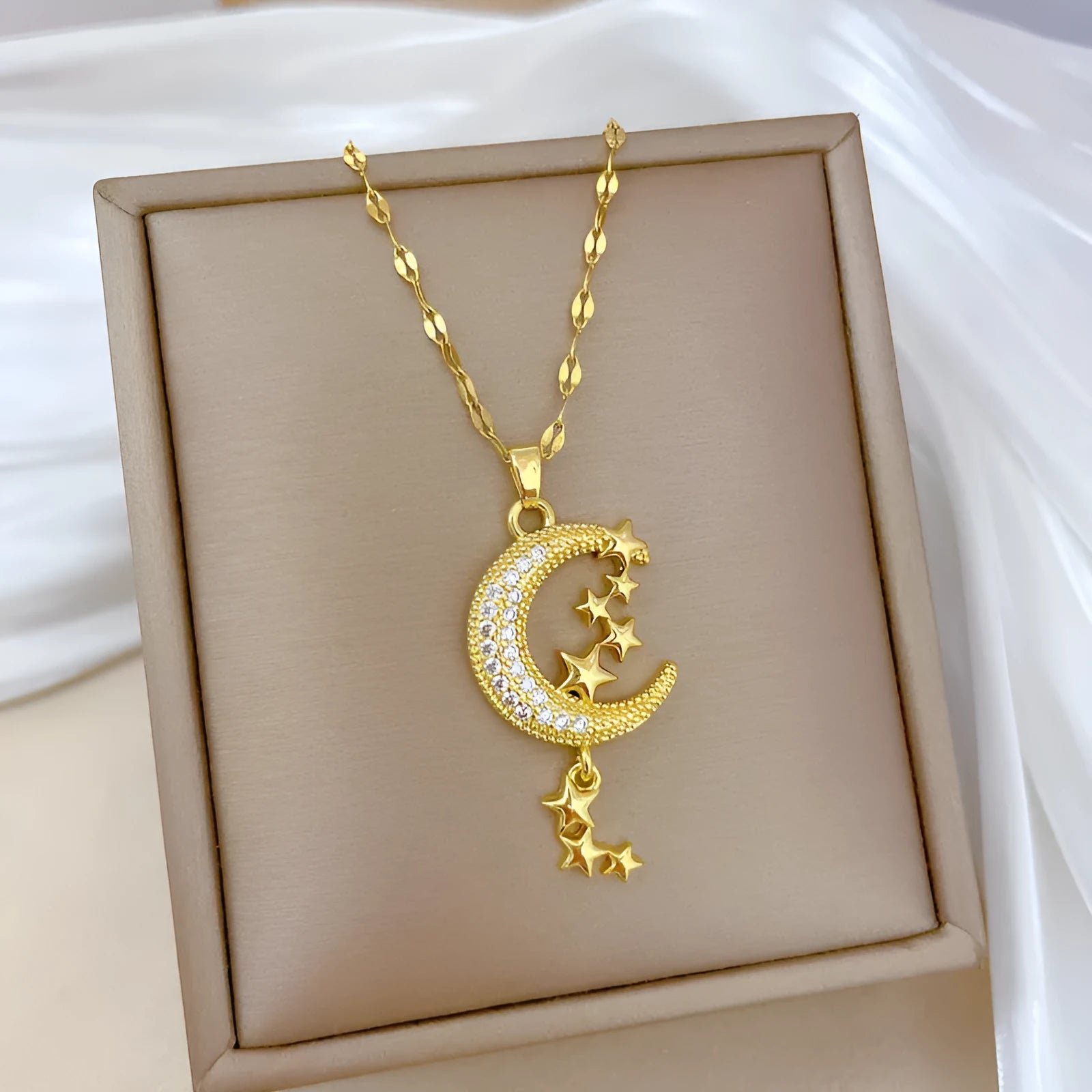 Geometric full moon pendant necklace with crystal setting and tassel on a stainless steel chain.