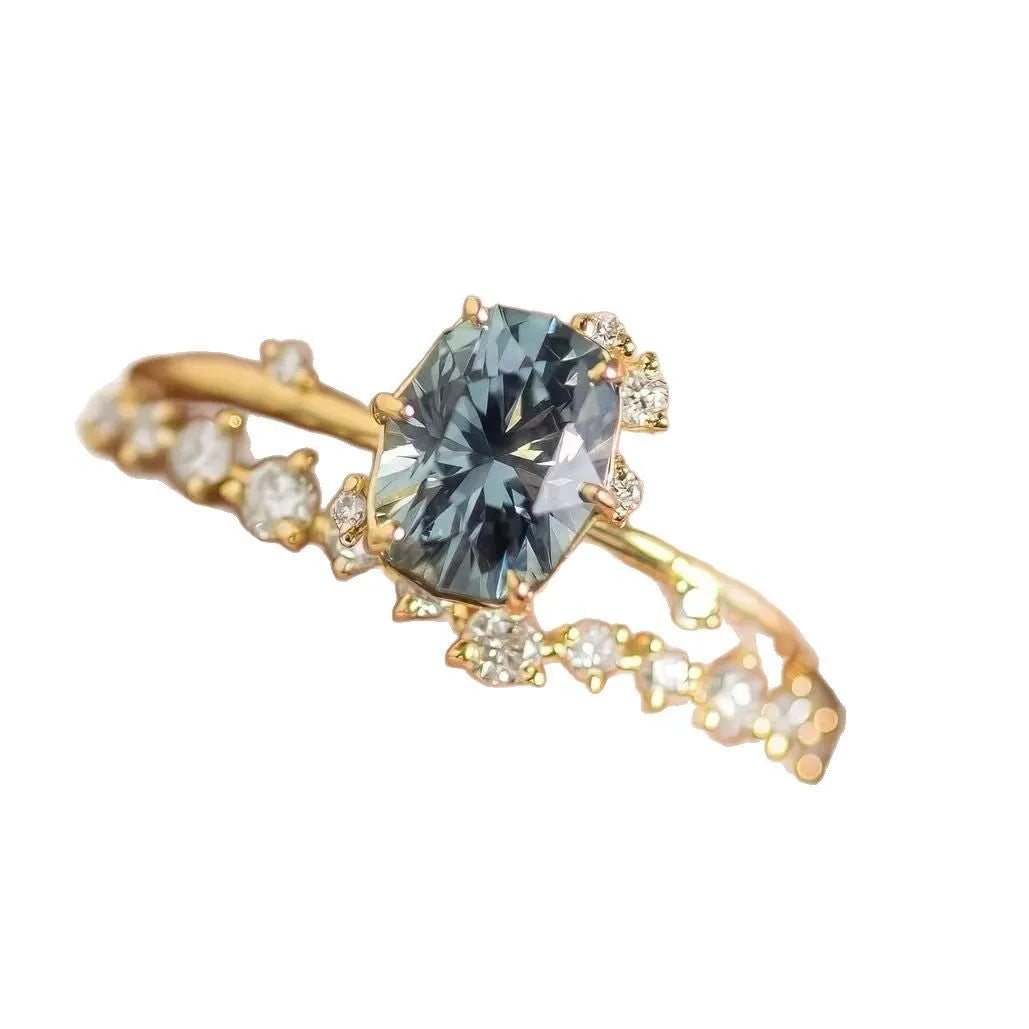 Gold plated floral ring with green zircon stone inlay on a hand, showing side profile and detail.