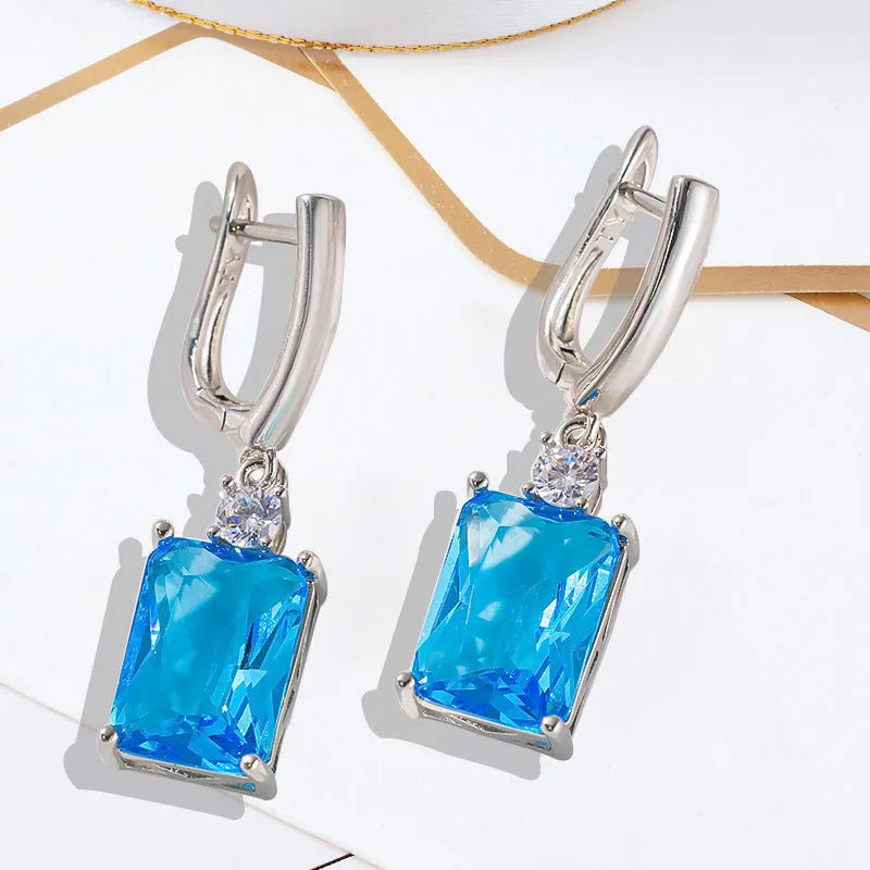 A pair of square geometric earrings in gold or silver colour, made from electroplated copper.
