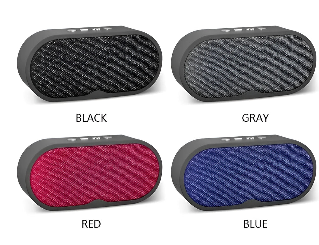 Portable grey Bluetooth wireless speaker with subwoofer and HD microphone on a table.