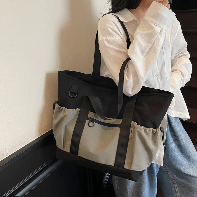 Lightweight Oxford cloth duffel bag for women in grey, shown with a yoga mat.