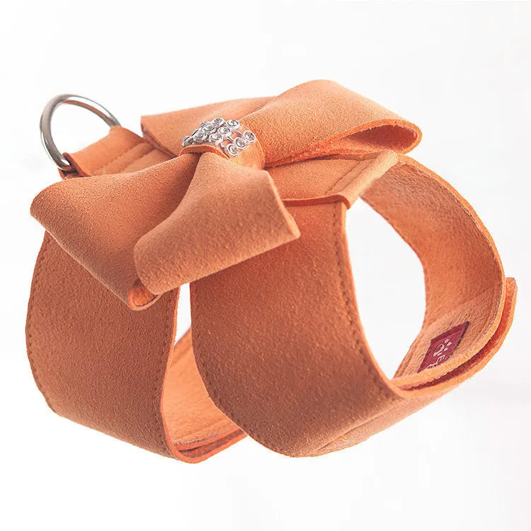 Pink microfiber puppy chest strap with a bowknot, showing the D-ring leash clip.