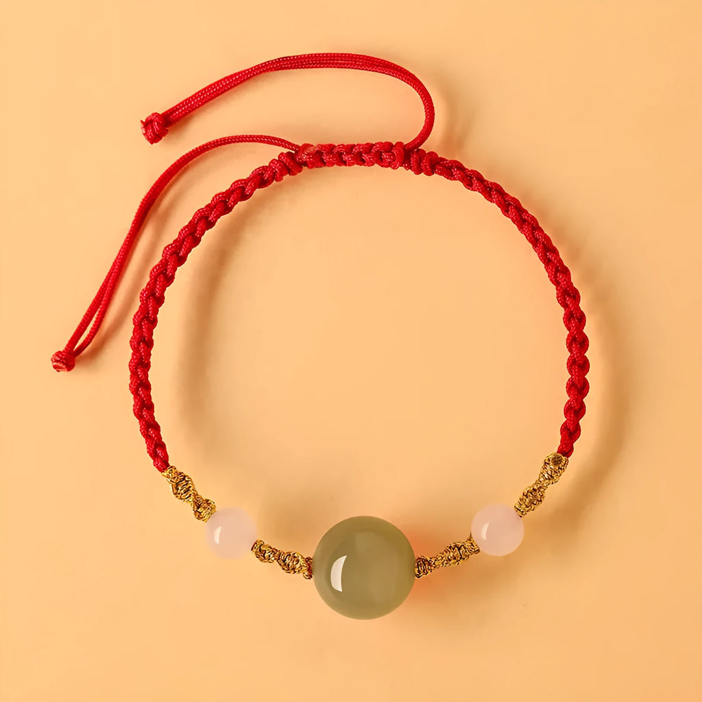 Hand-woven red rope bracelet with Hetian jade beads featuring traditional Chinese cultural symbols