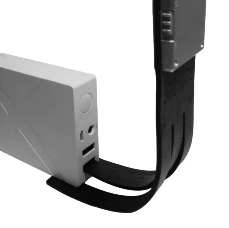 Black folding LED reading lamp showing compact folded design with USB charging port