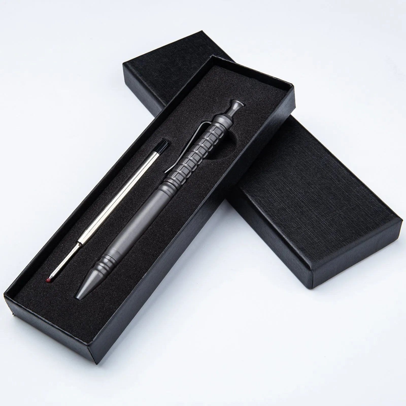Gunmetal grey titanium alloy tactical pen with push-action mechanism and 0.5mm nib in a gift box.