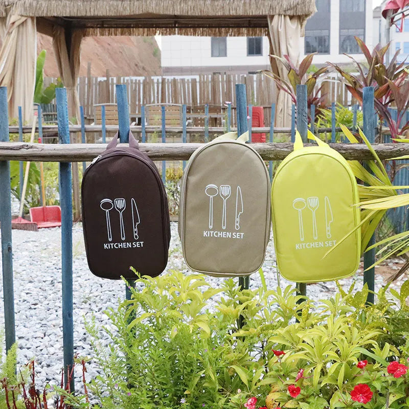 Portable storage bag containing a 12-piece stainless steel picnic cutlery set for outdoor use.