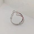 Gold brass opening ring with sphere design on a white background.