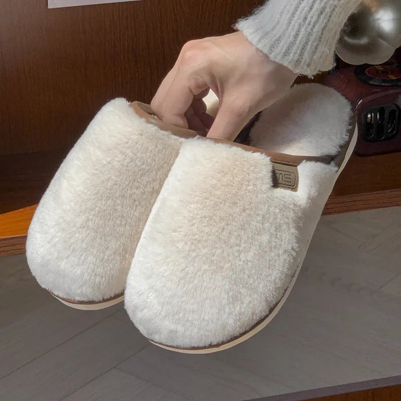 Solid colour plush slippers with PVC non-slip sole and car stitching detail on the upper.