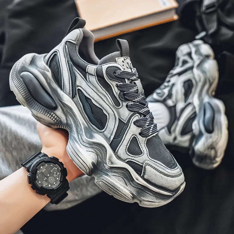 Men's black and white low-top mesh sneakers with a platform sole and lace-up front.