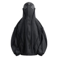 Man wearing a black loose-fit zip-up hooded cotton coat with an abstract pattern.