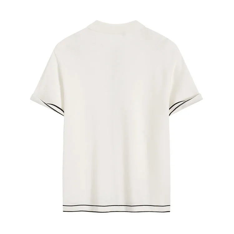 White short-sleeve cardigan with dark contrast lapels, shown on a model, old money style.
