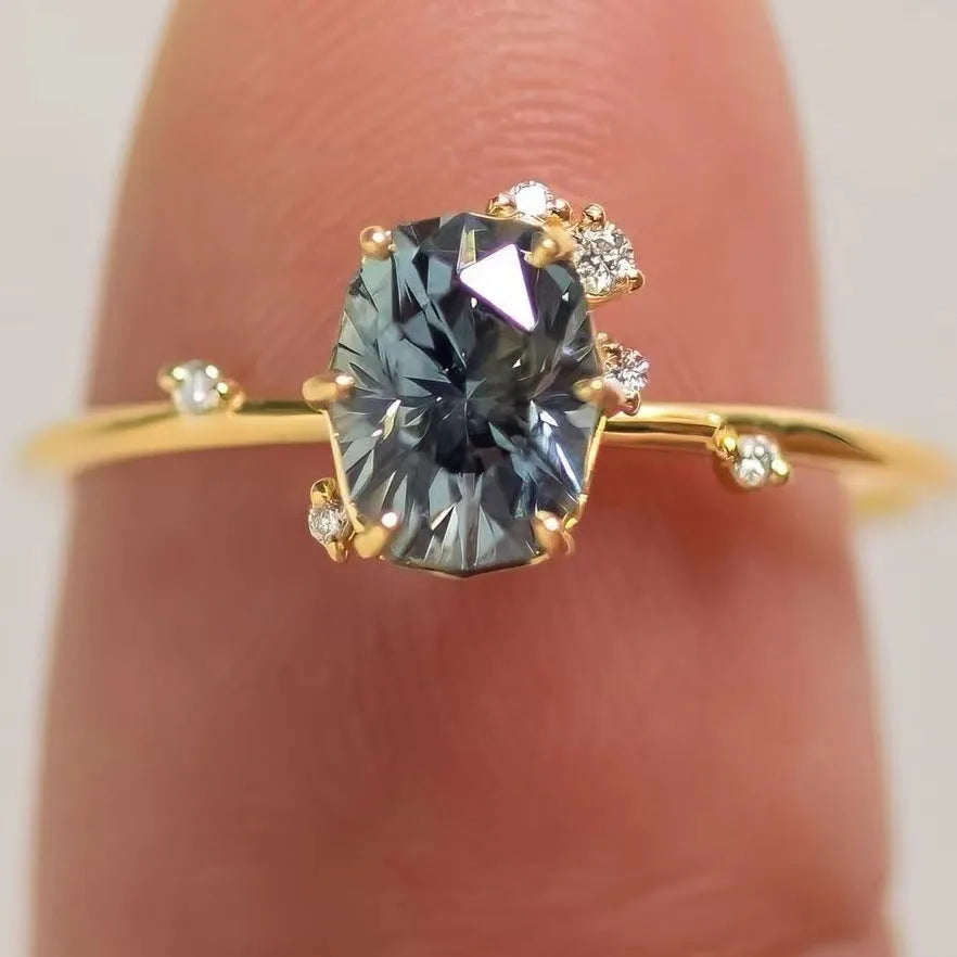 Gold plated floral ring with green zircon stone inlay on a hand, showing side profile and detail.