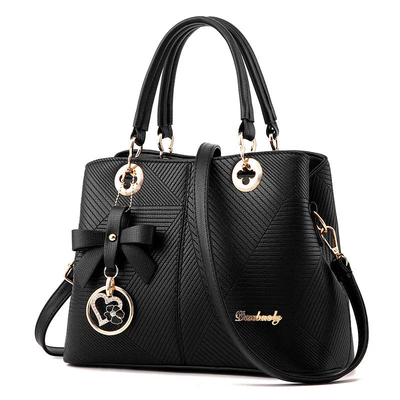 A structured navy blue PU leather crossbody bag with a gold zip, shown on a model with an adjustable shoulder strap.