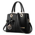 A structured navy blue PU leather crossbody bag with a gold zip, shown on a model with an adjustable shoulder strap.