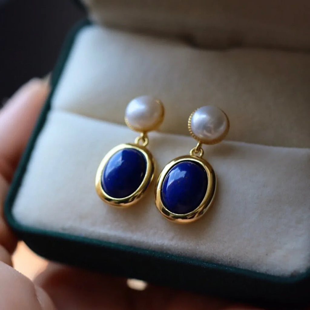 A pair of lapis lazuli pearl drop earrings on 925 silver posts with engraved patterns.