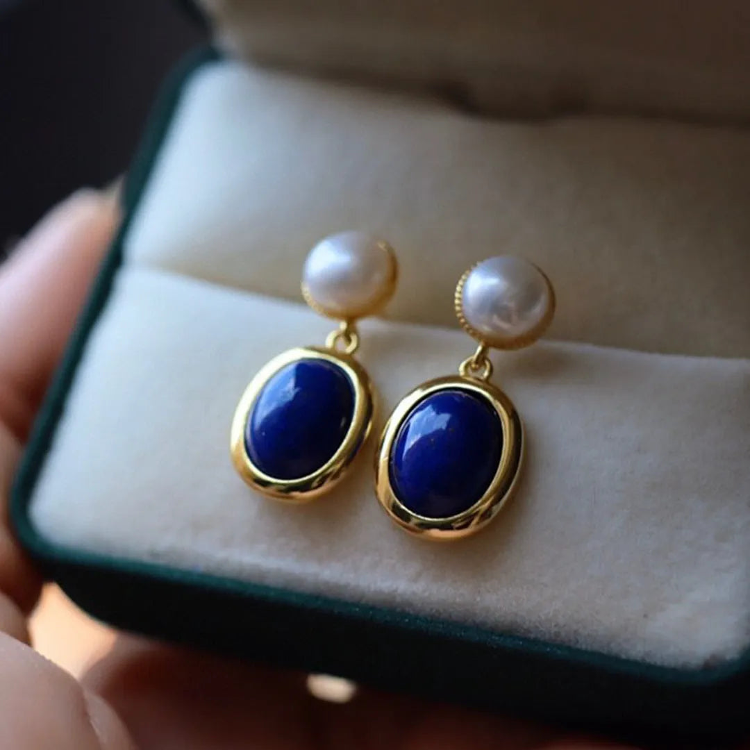 A pair of lapis lazuli pearl drop earrings on 925 silver posts with engraved patterns.