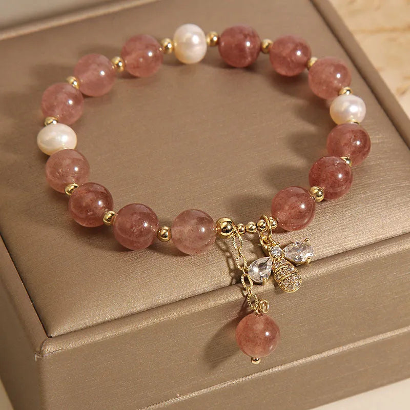 Women's bracelet with strawberry quartz beads, three freshwater pearls, and sparkling zircon details on a metal chain.