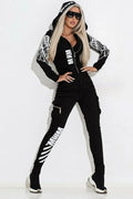 Black women's printed hooded zip-up top and matching trousers street suit.