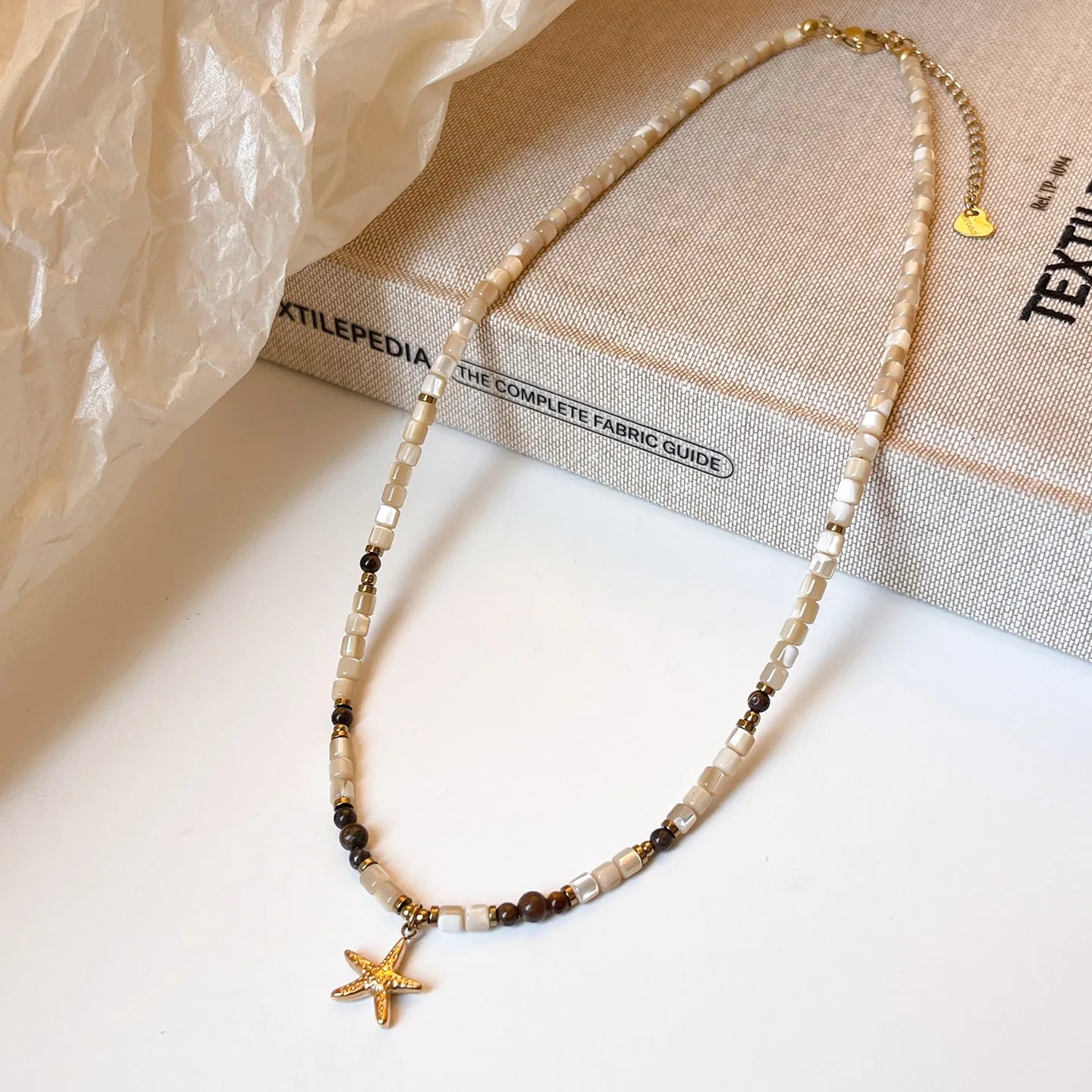 Titanium steel starfish pendant necklace with natural shell and tigereye on a beaded Maillard style chain