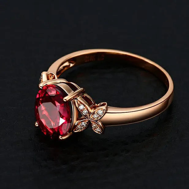 Close-up of a women's rose gold plated butterfly ring shaped like a heart with coloured enamel details.