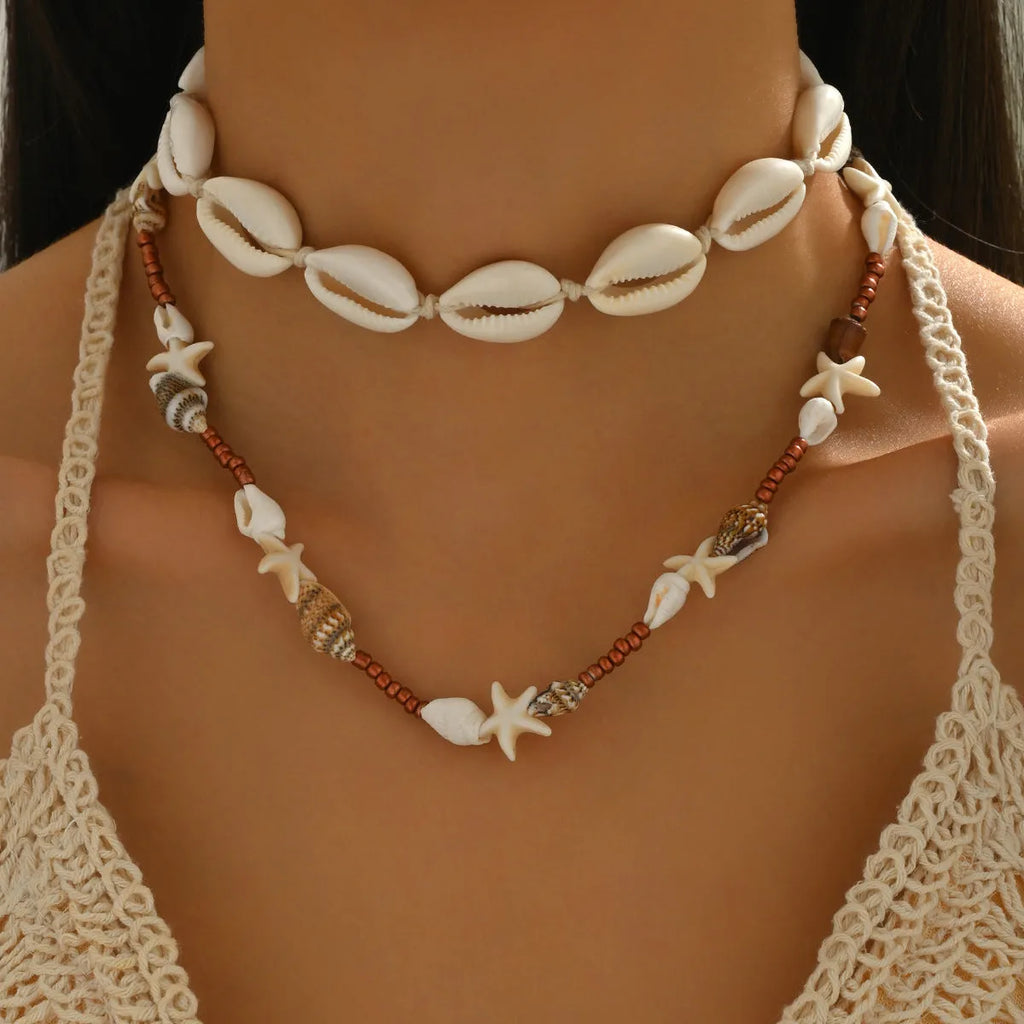 Handcrafted Bohemian shell necklace with geometric pendant on regular chain