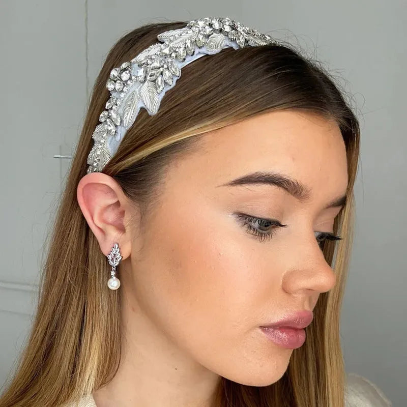 Geometric earrings with white floral micro inlay on a gold, rose gold, or platinum plated background.
