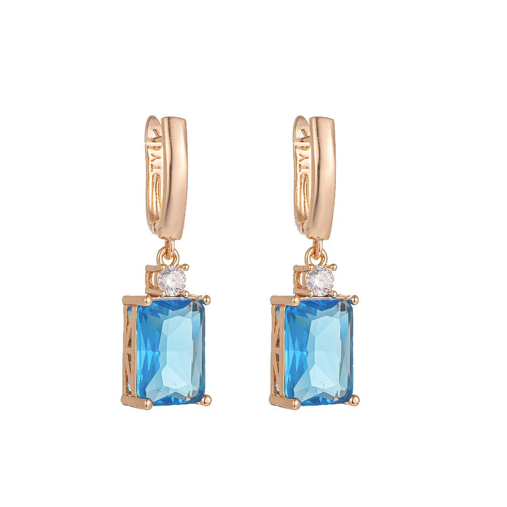 A pair of square geometric earrings in gold or silver colour, made from electroplated copper.