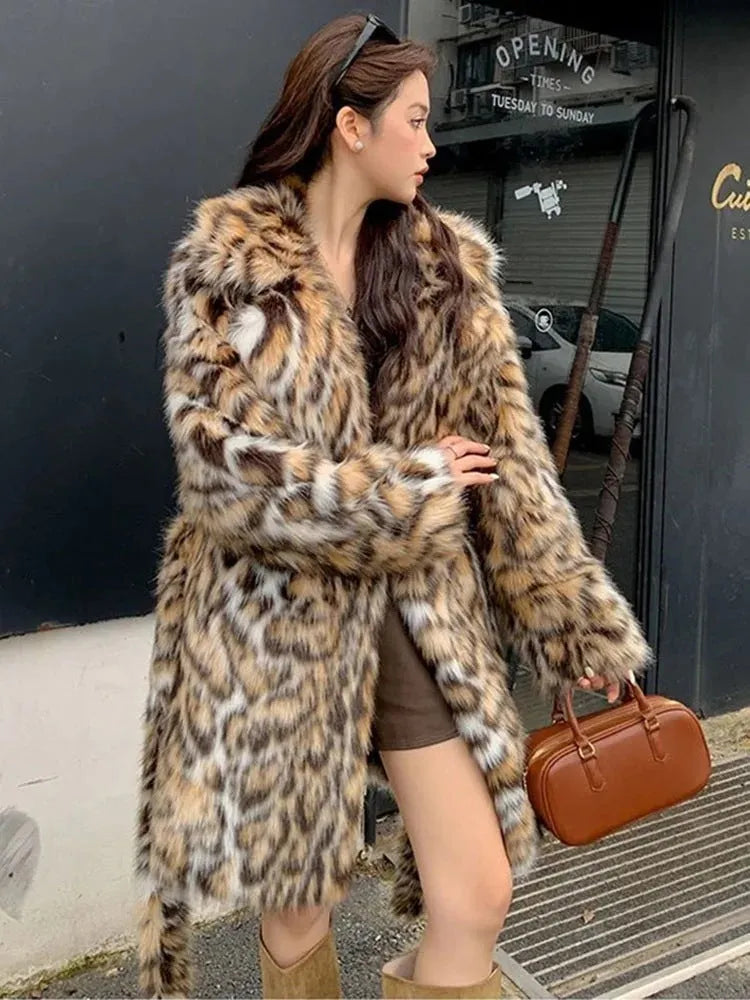 A model wearing a long faux fur coat with a fur collar and pockets.