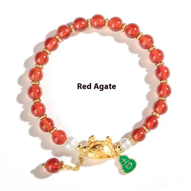 Close-up of an 8mm diamond-shaped bead bracelet in red agate, showing its unisex design.