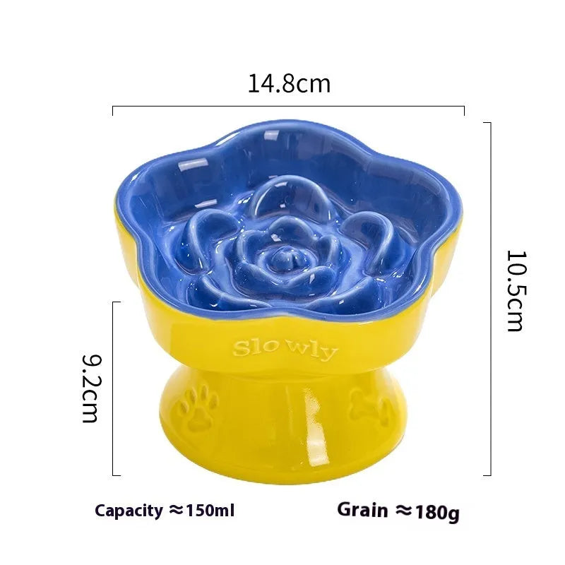 White ceramic pet bowl with high chin rest and broad, weighted foot base on a wooden floor