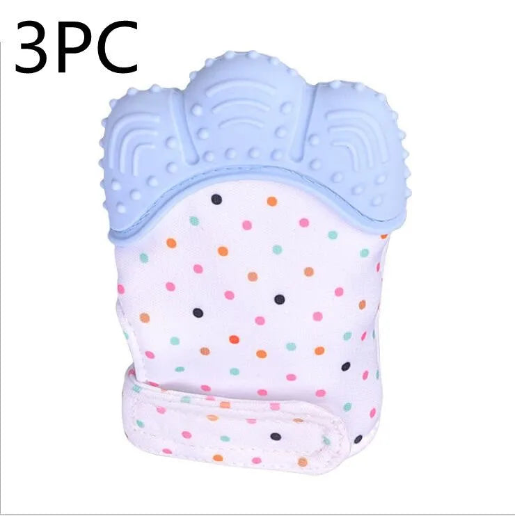 BPA-free silicone baby teether glove fastened with a white Velcro strap on a baby's hand