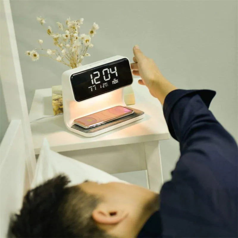 White bedside lamp with wireless charging pad and LCD clock display on base