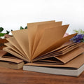 Brown and white kraft paper sketchbooks in large 16K and medium 32K sizes, showing bound 132-page pads.