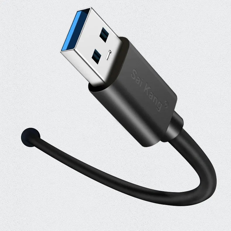 Black USB male to female extension cable on a desk, showing connector ends.