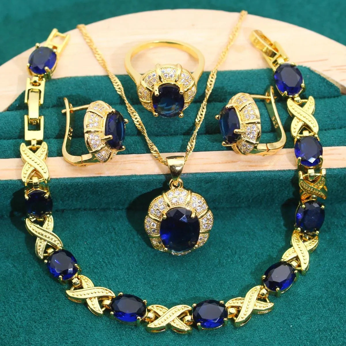 An 18k gold plated jewellery set featuring a necklace, earrings, a ring, and a bracelet with coloured cubic zirconia stones.