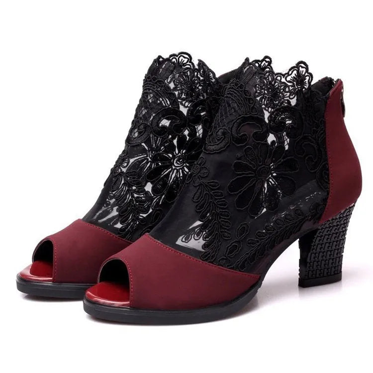 Women's black lace gladiator sandals with a square high heel and peep toe, showing zip closure
