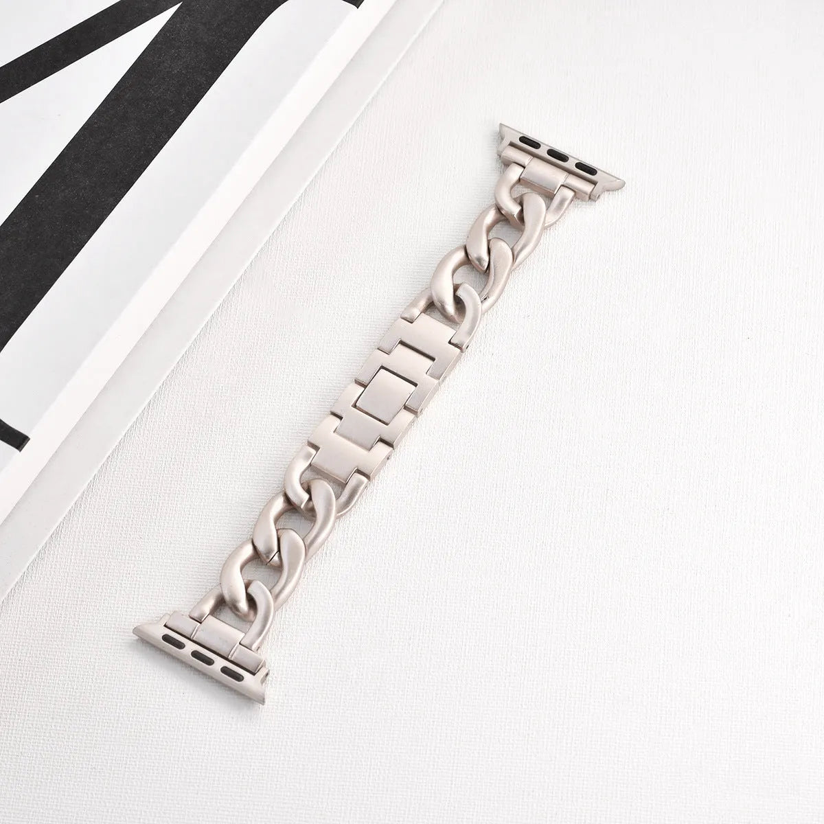 Metal denim chain watch strap for Apple Watch in multiple colours on a grey background.