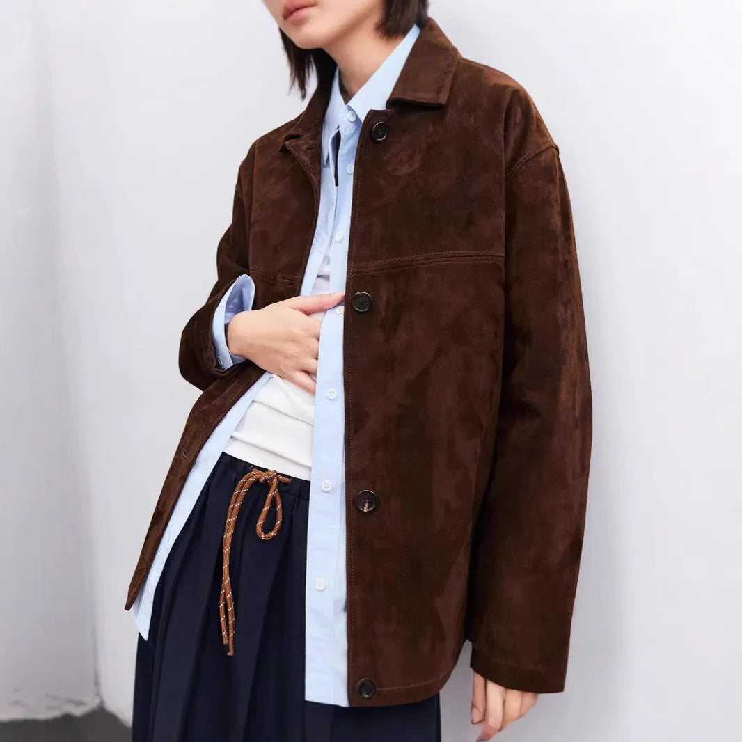 Yellow brown cashmere mid-length coat with a leather belt and a flat Peter Pan collar on a hanger.