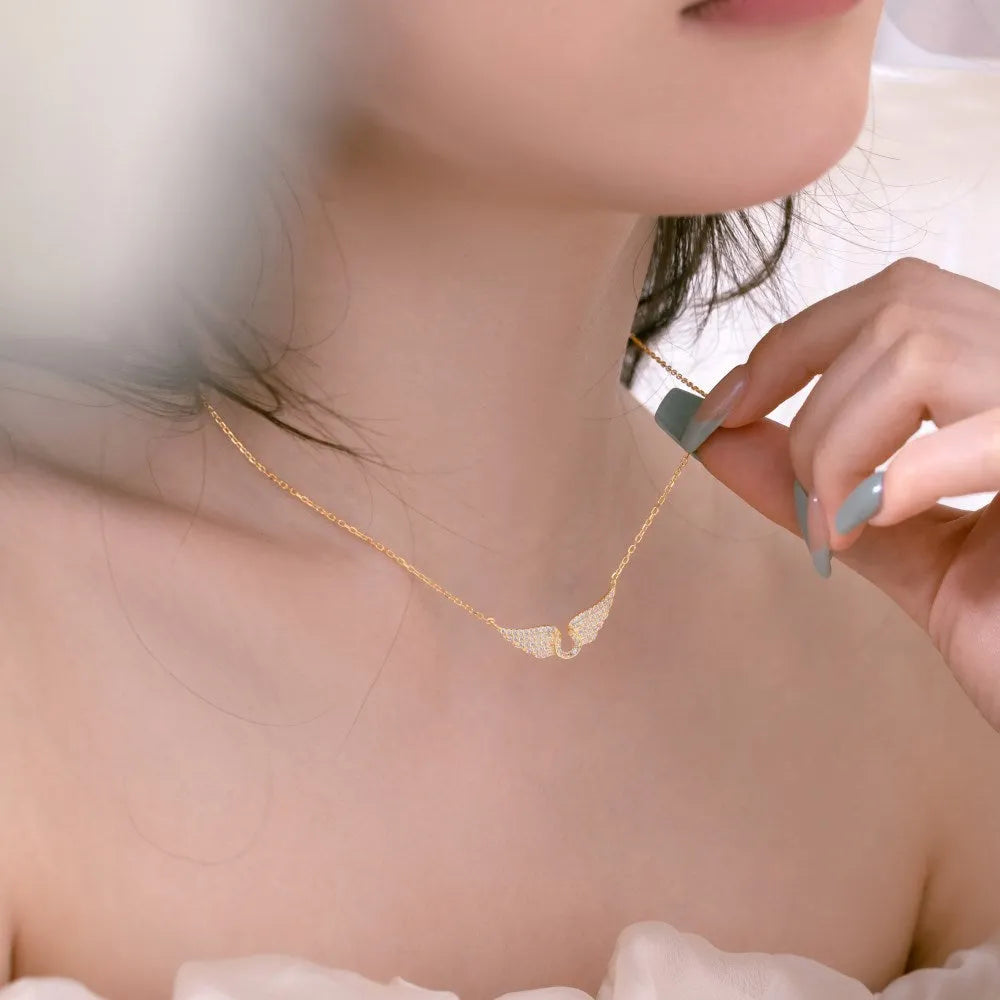 925 sterling silver wings fashion necklace on display with electroplated finish in white or yellow gold tone