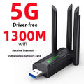 Black external USB network transmitter device with four extended antennas.