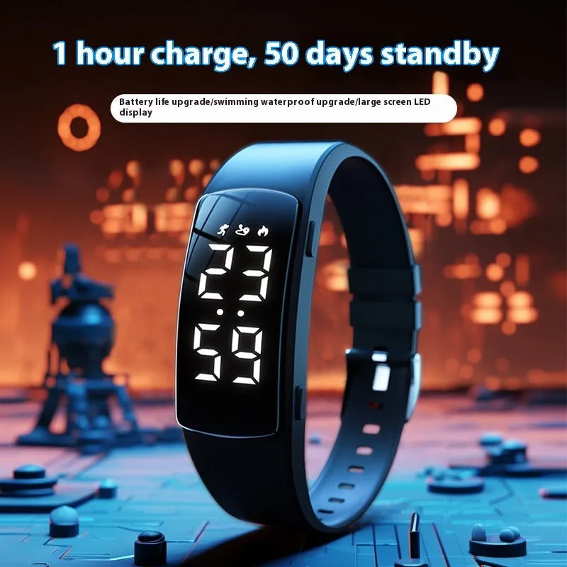 Black electronic digital watch with LED display and silicone strap on a wrist.