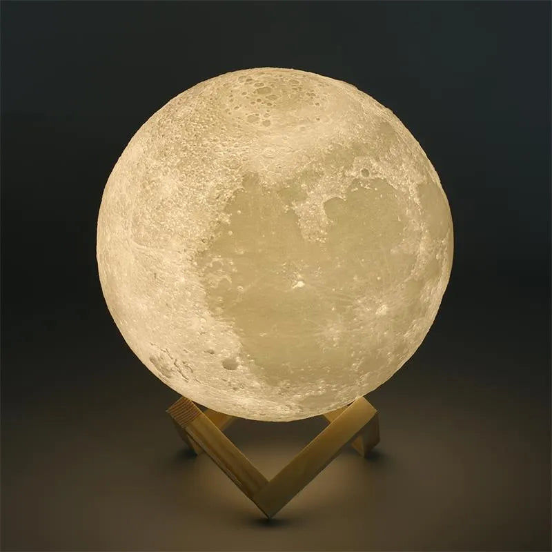 3D printed white moon lamp with detailed lunar surface texture on a wooden holder.