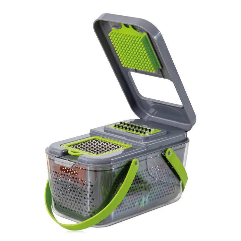 Grey multifunctional vegetable cutter with stainless steel blades, foldable compartments, and water filter basket on a kitchen countertop.
