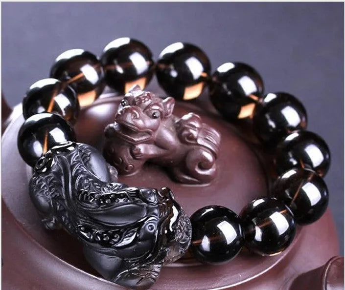 Kaiguang natural ice species black anthracite raspberry stone beaded bracelet on a plain background