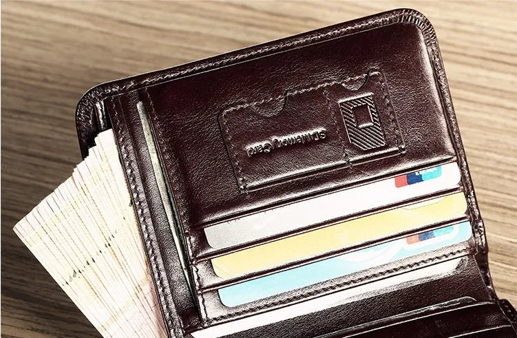 Men's black full-grain leather bifold wallet open, showing eight card slots and a zipped coin pocket.
