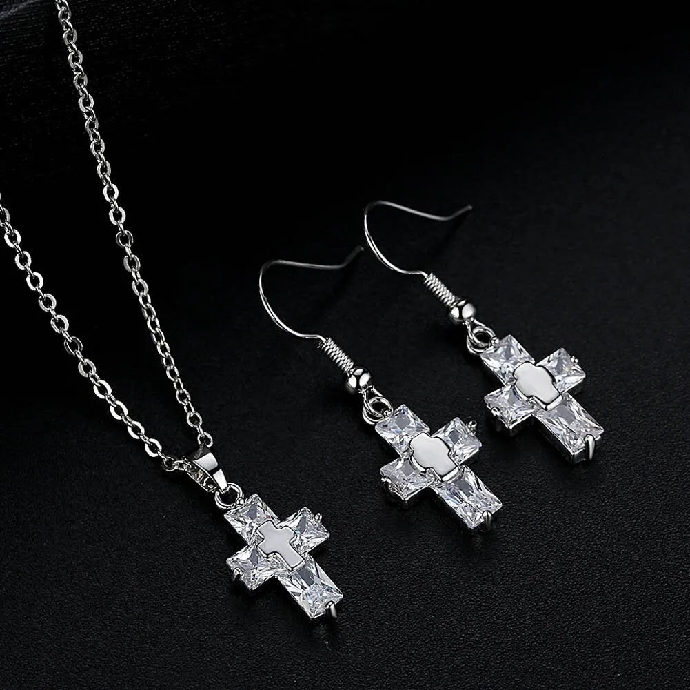 Gold cross pendant and matching stud earrings set on a light background showing compact 1.2 x 2.2 cm pendant and 3.3 x 1.2 cm studs