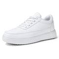 Women's white leather lace-up flat casual shoes on a plain background.