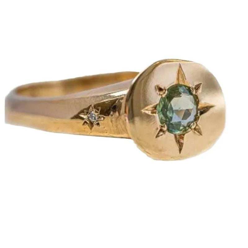 Gold colour adjustable ring with a star-shaped zircon stone set flush into an oval zinc alloy band.
